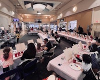 a group of people sitting at tables in a mall