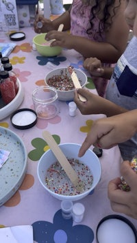 a group of children are making crafts at a table